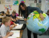 Teacher educating students with globe